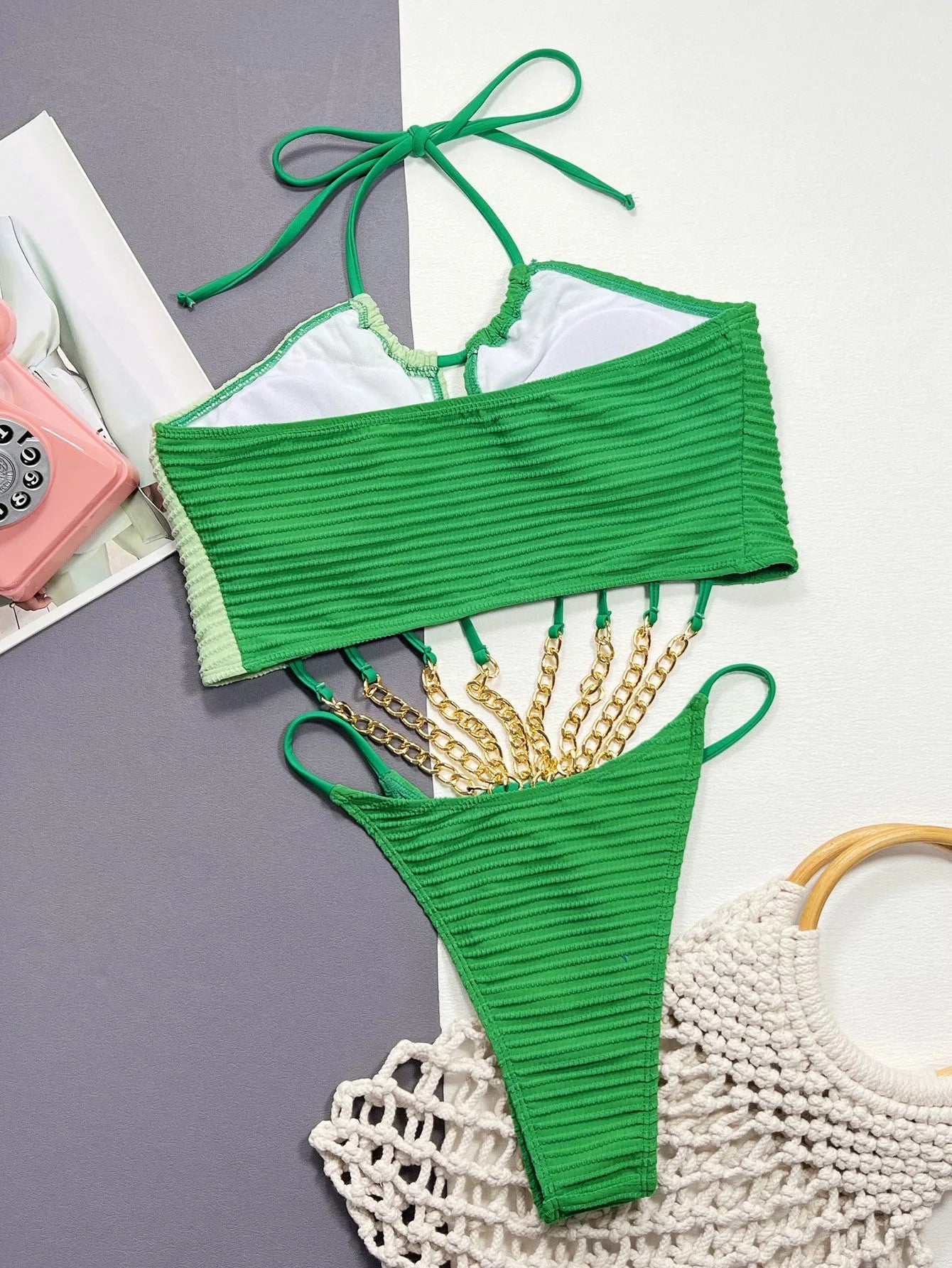 Green women's one-piece swimsuit with a hollow sexy cut on a mannequin.
