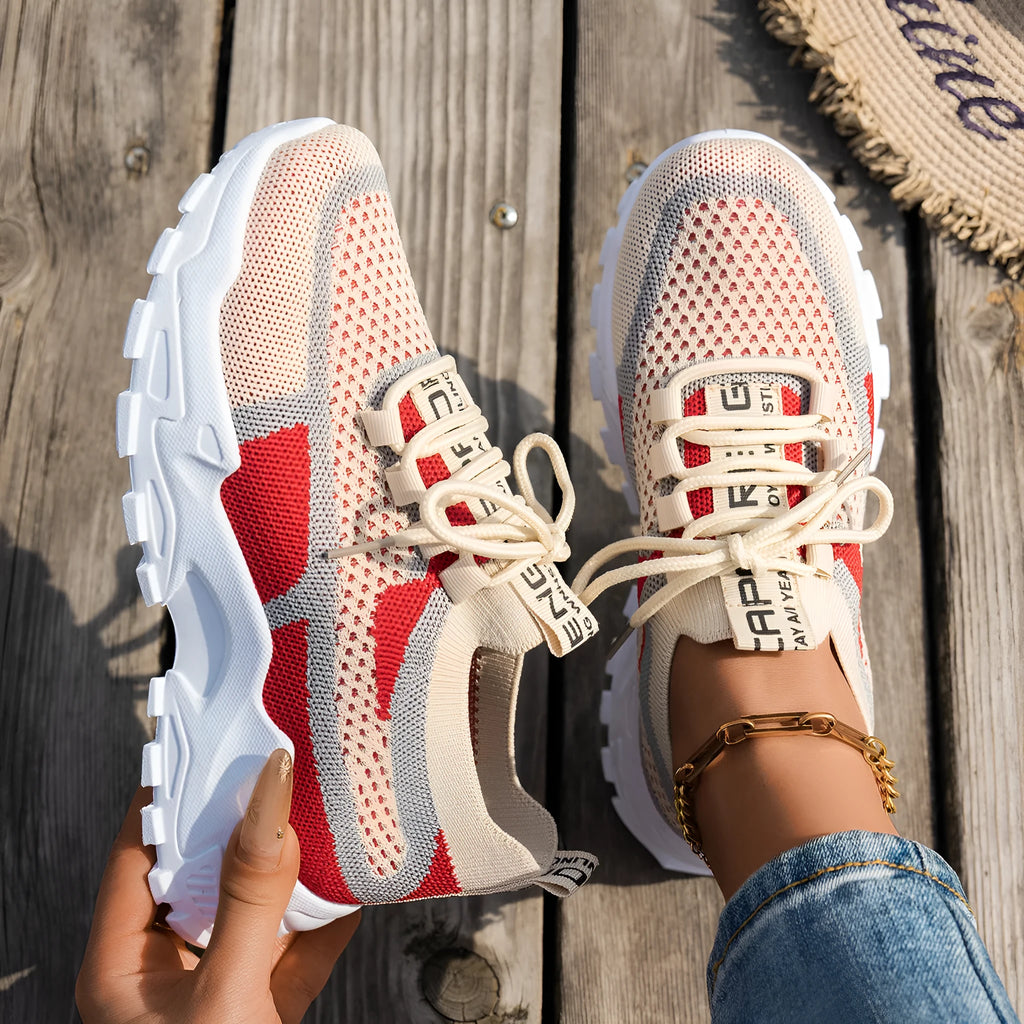 Women's Flyknit Mesh sneakers in a neutral colour showing lace-up design and rubber sole.
