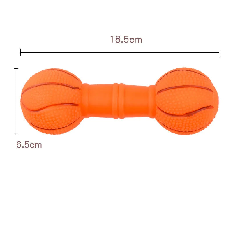 Brown orange white yellow PVC football dumbbell shaped squeaky dog chew toy on a plain background.