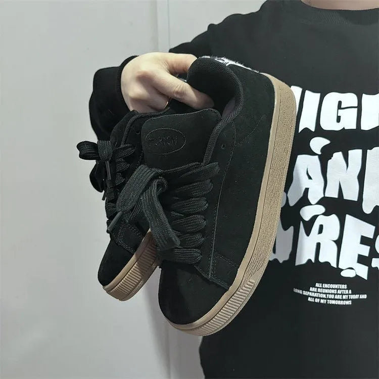 Retro black low-top sneakers with round toe, waterproof platform, and injection-moulded rubber sole