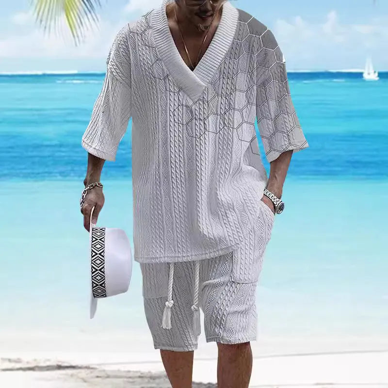 Printed men's knitted drop-shoulder short-sleeved top and matching shorts set in a polyester blend.