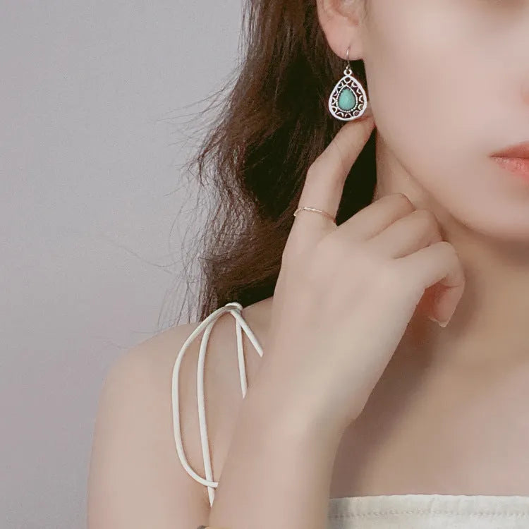 Pair of retro alloy earrings for women in triangle style with national design for travel and photo outfits.