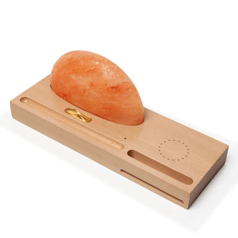 Natural crystal salt lamp with solid beech wood base and integrated Qi wireless phone charging pad.