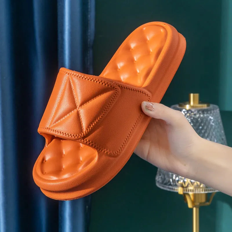 Pair of thick-soled EVA bathroom slippers in various colours, showing non-slip sole texture.