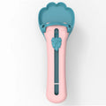 Green and pink pet food scooper spoon with squeezer handle and extruded feeder tip for dispensing treats.