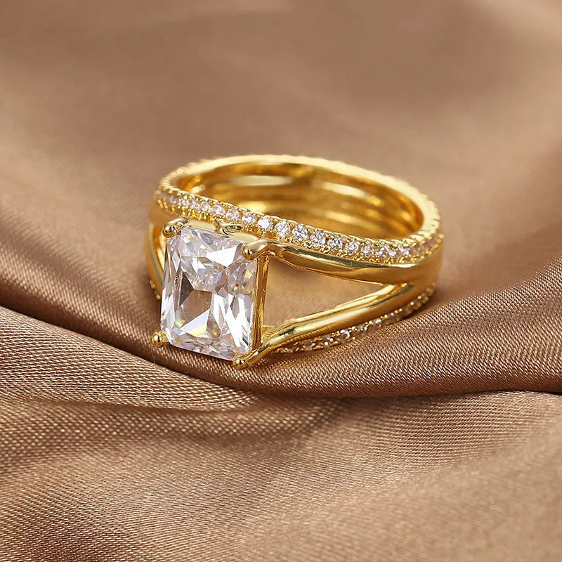 Gold colour geometric women's ring with a square zircon stone on a copper band.