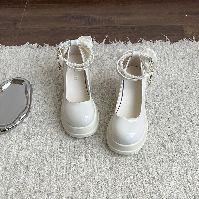 Beige and black women's Mary Jane shoes with a chunky heel and round toe.
