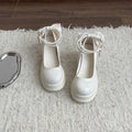 Beige and black women's Mary Jane shoes with a chunky heel and round toe.