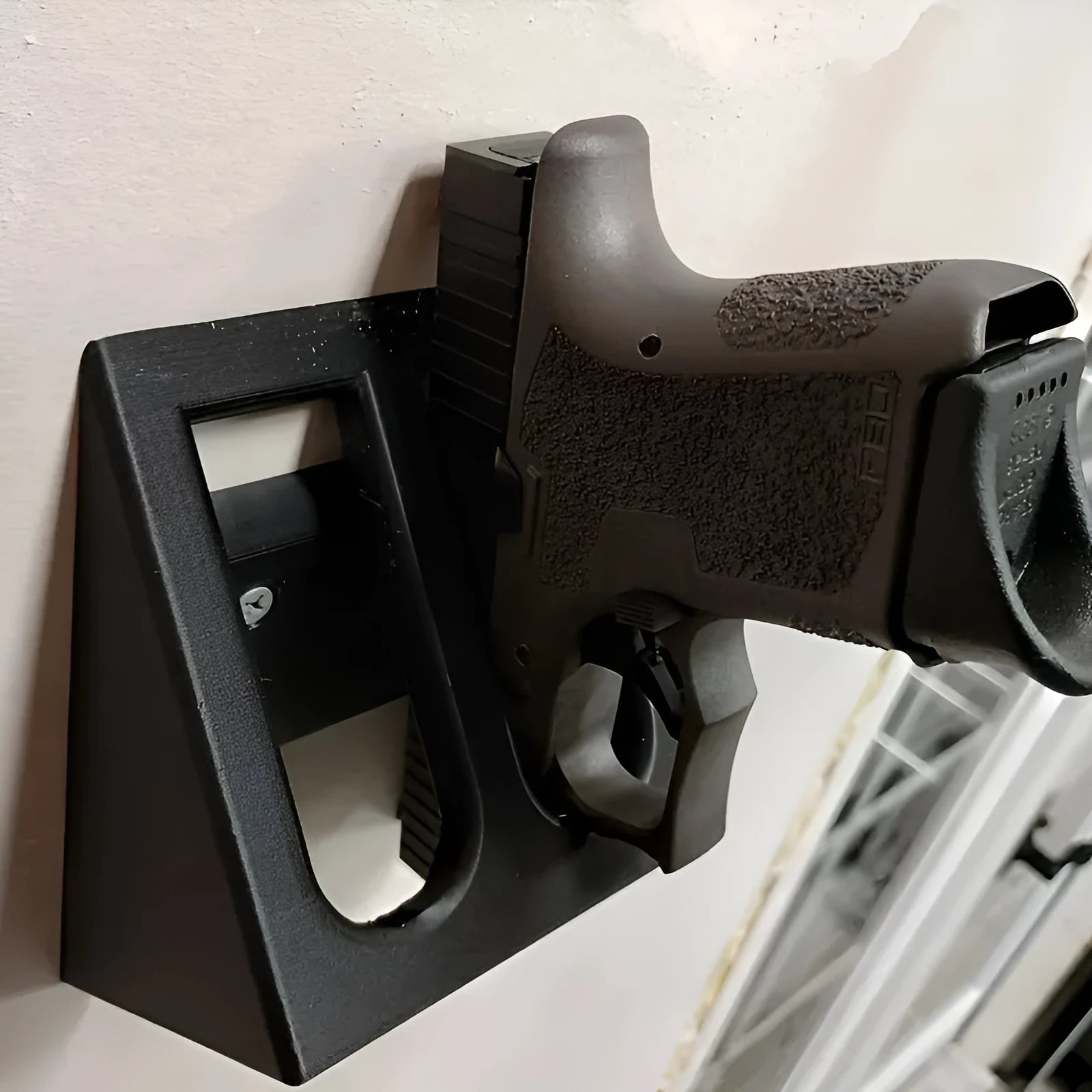 Black plastic pistol stand with punk-style finish for displaying collectible handguns