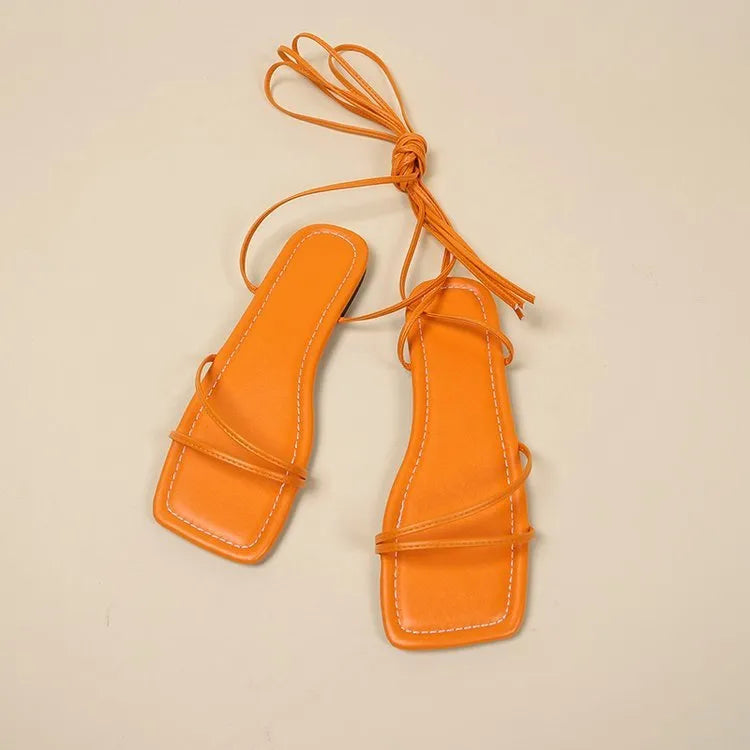 Women's flat sandals with ankle bandage strap in white, featuring a square toe and front lace-up.