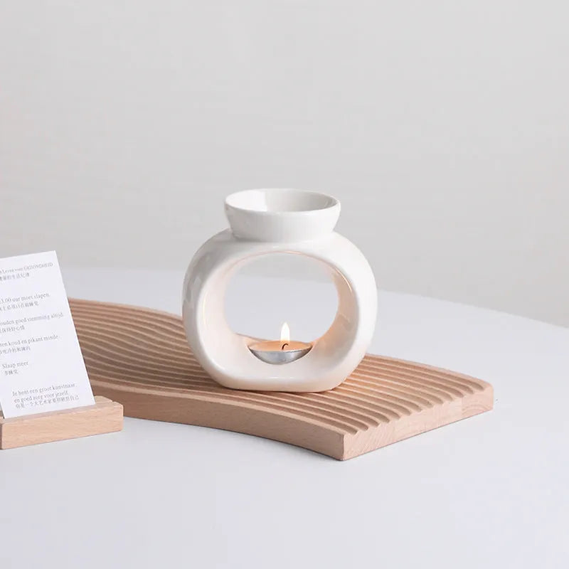White Nordic minimalist ceramic aromatherapy stove ornament for indoor fragrance diffusion.