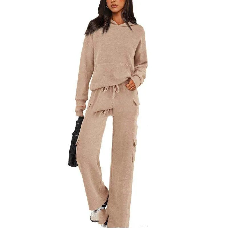 Women's two-piece leisure sports suit in polyester, showing long sleeve top and trousers in a solid colour.