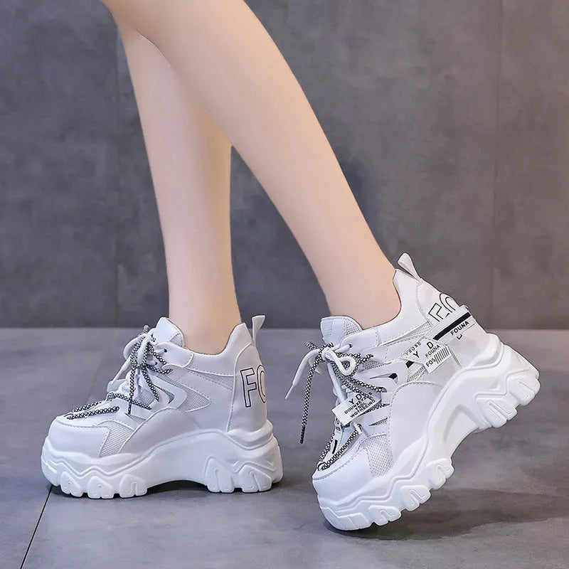 White women's low-top platform sports shoes with breathable mesh, cross strap, and rubber sole.