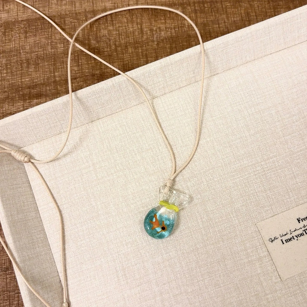 Women's necklace with coloured glaze pendant on a cotton and linen clavicle chain.