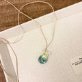Women's necklace with coloured glaze pendant on a cotton and linen clavicle chain.