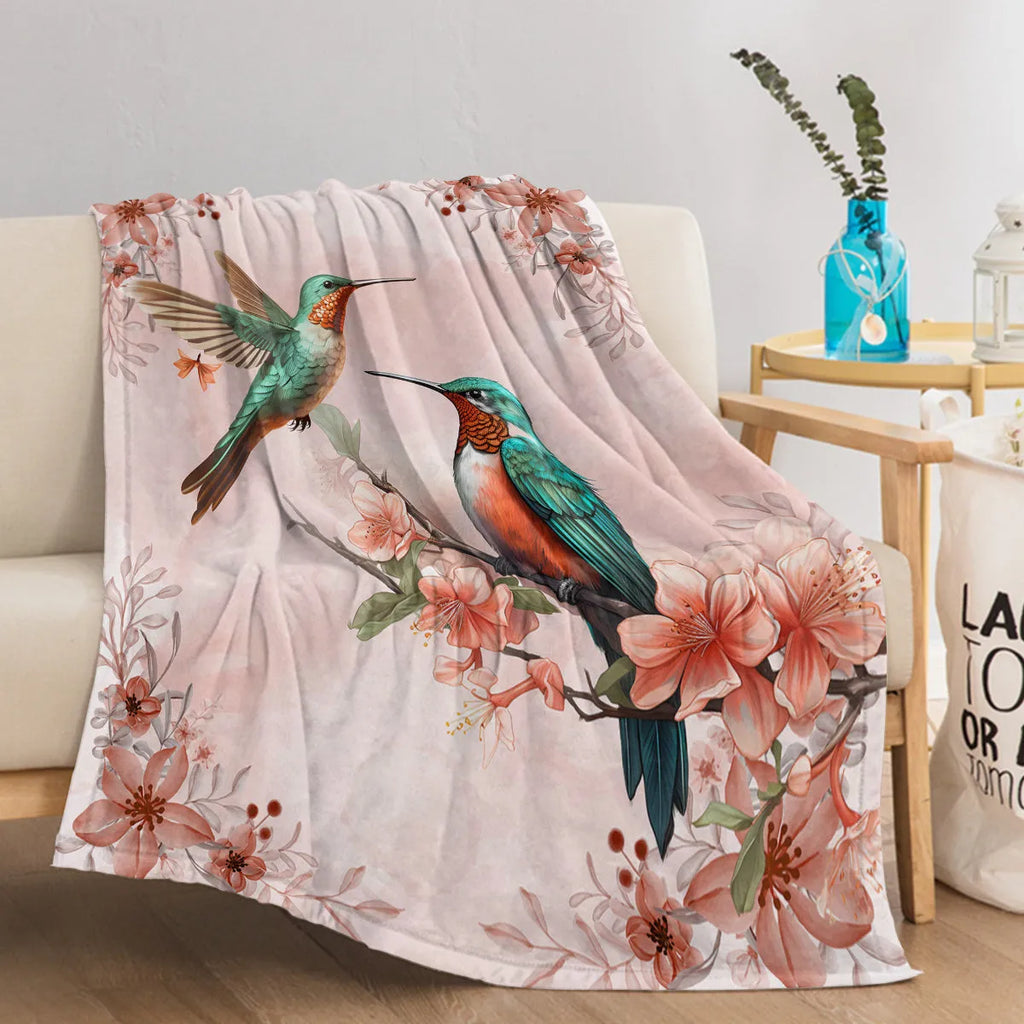 Pink hummingbird floral flannel velvet fleece throw blanket on sofa