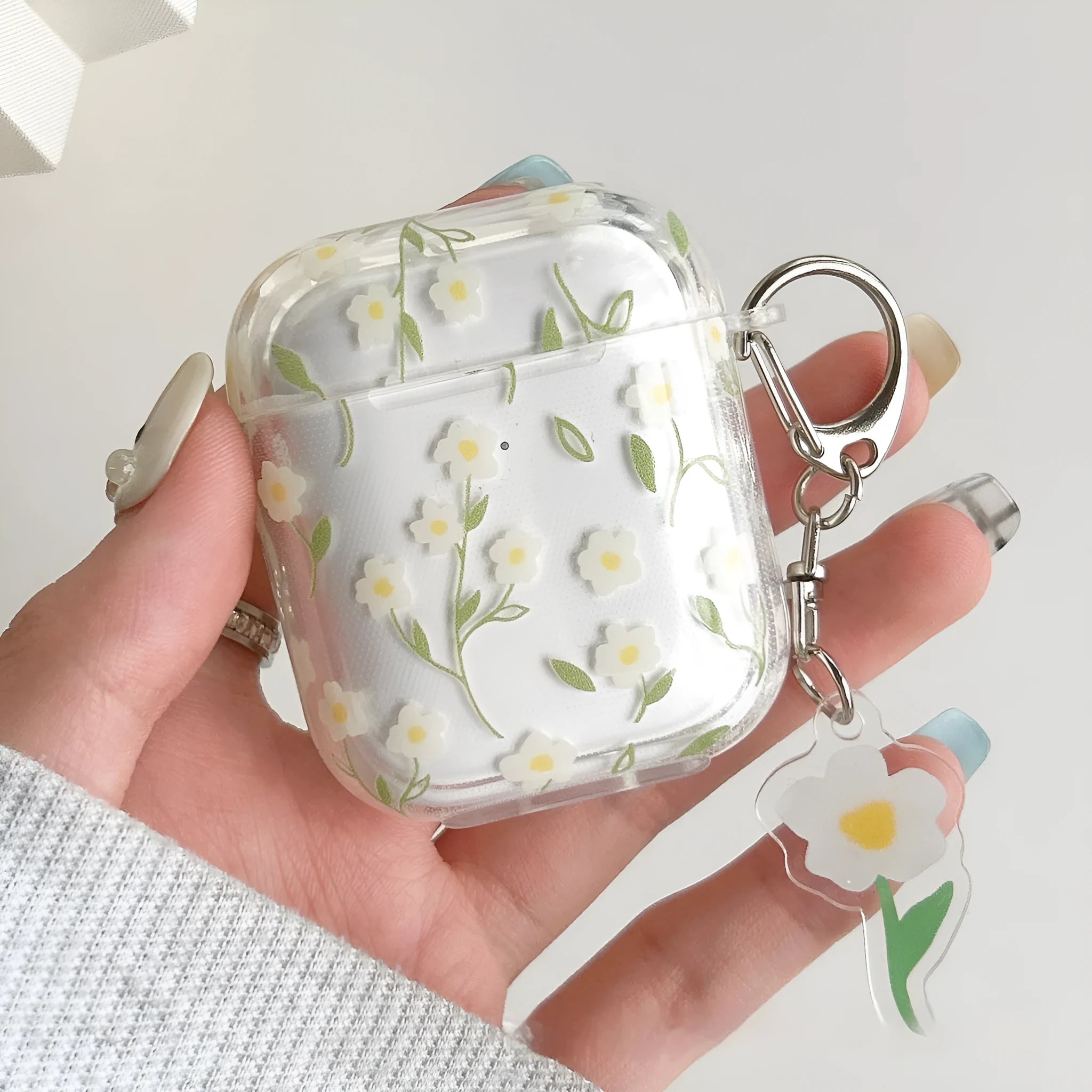 Clear soft TPU protective case for Apple AirPods with white floral oil painting decoration.