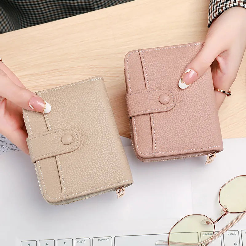 Ladies short pu leather wallet with lychee pattern in beige, showing two-fold design with card slots.