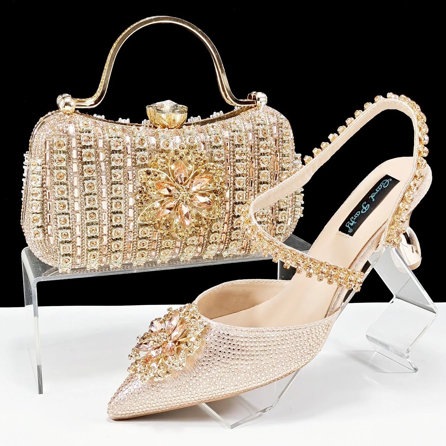 Women's high heel shoes with matching clutch bag featuring decorative flower buckle and ankle chain detail