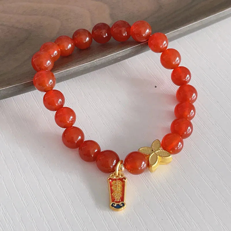 Handmade red agate bracelet with dragon and lucky bag Chinese designs for women.