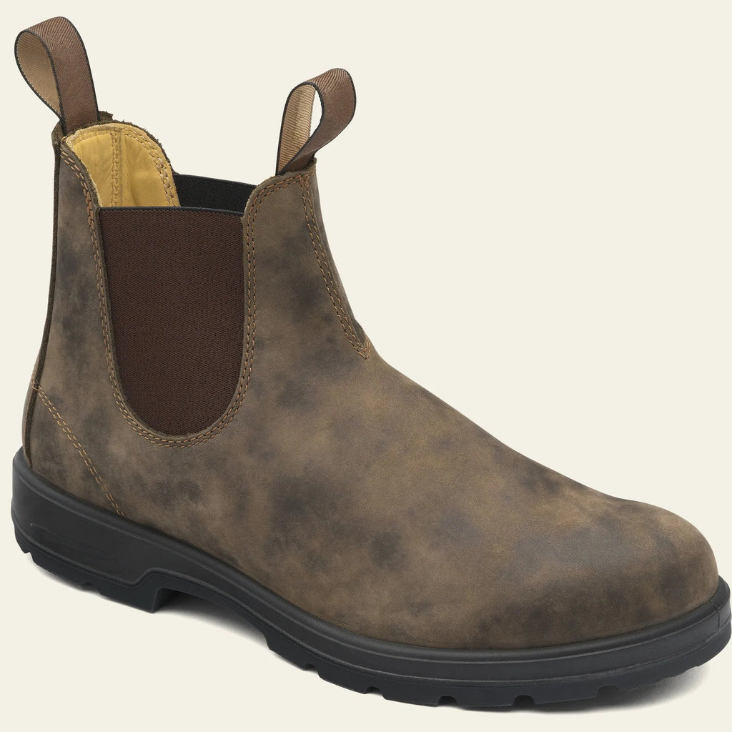 Vintage brown unisex Chelsea boots with a frosted finish, round toe, and low horseshoe heel on a wooden floor.