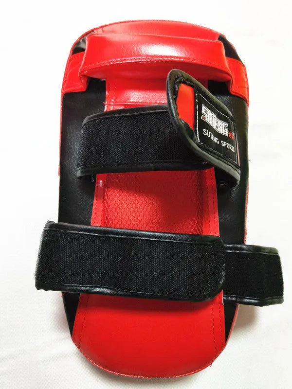 Black and red hand-held martial arts target pad with buckle strap on the back.