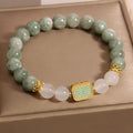 Women's oil green emerald crystal bracelet with five scriptures design on white background
