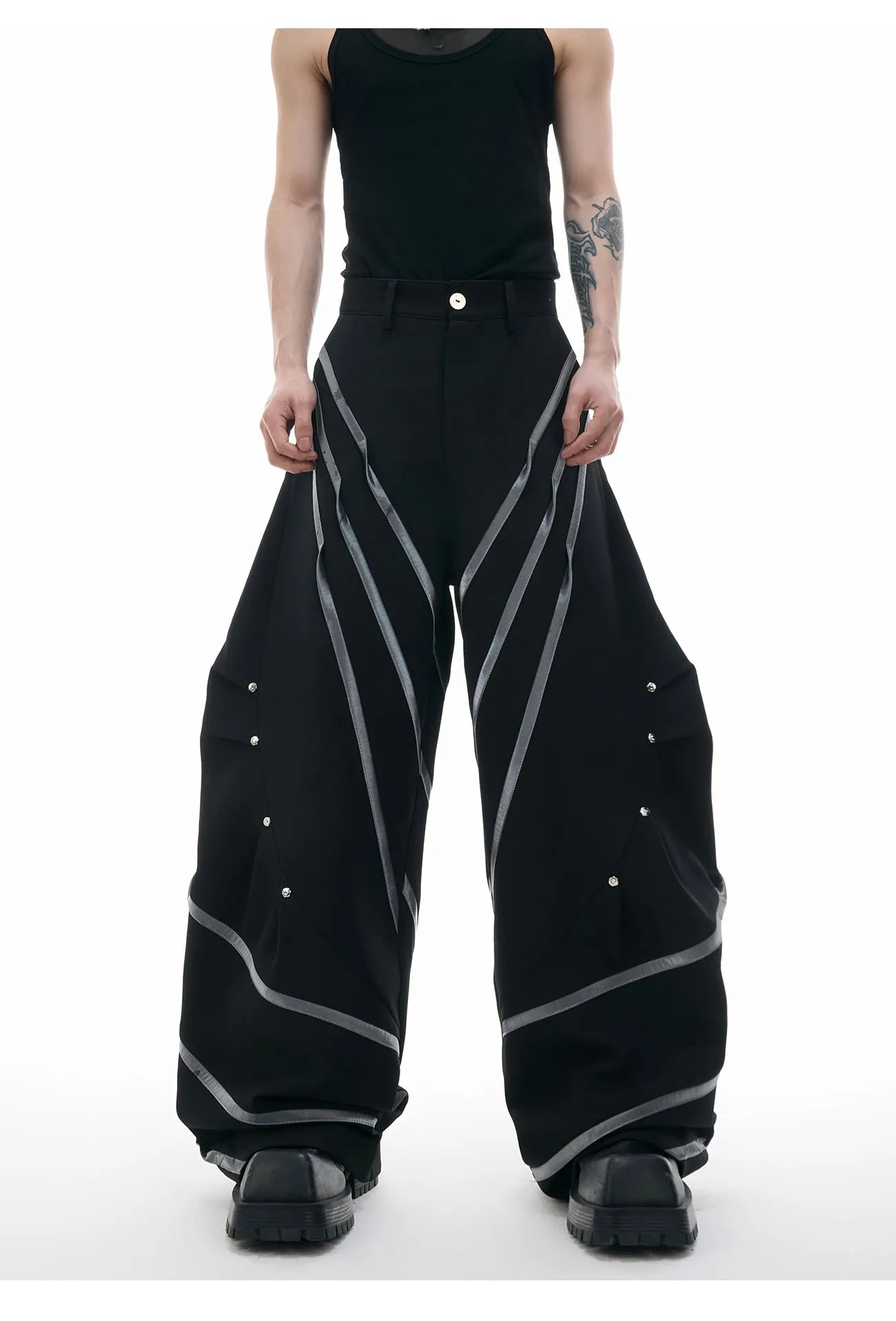 Men's trousers with metal striped rivet pleated design showing three-dimensional cutting detail