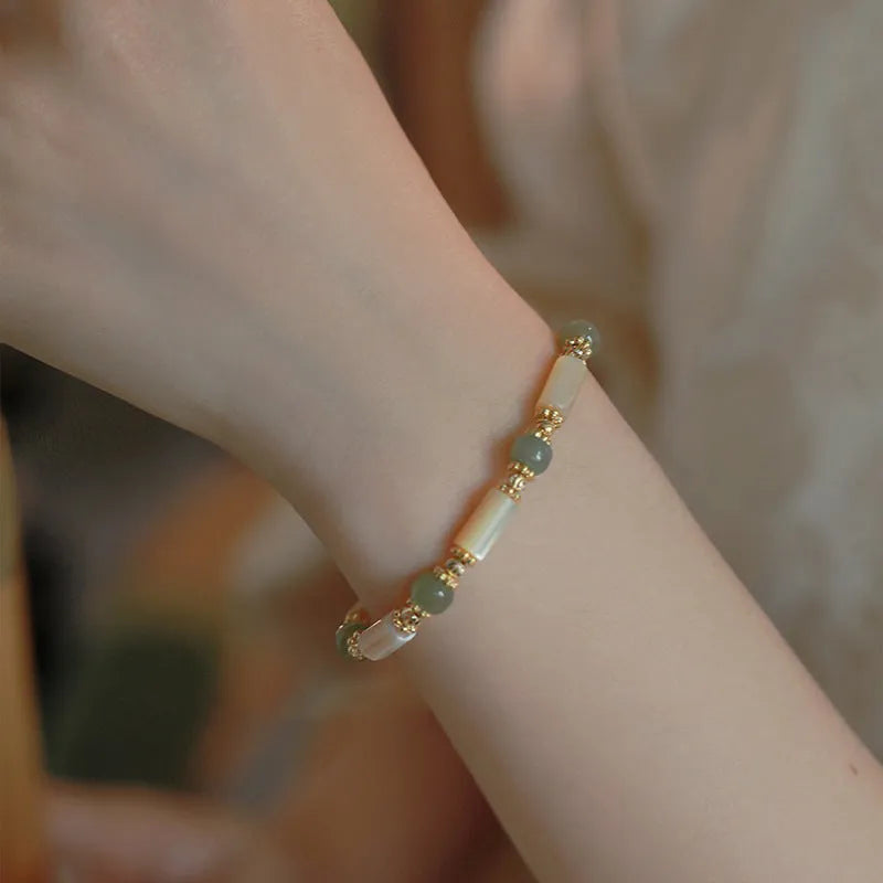 Hetian jade white lip shell bracelet with geometric round design on wrist