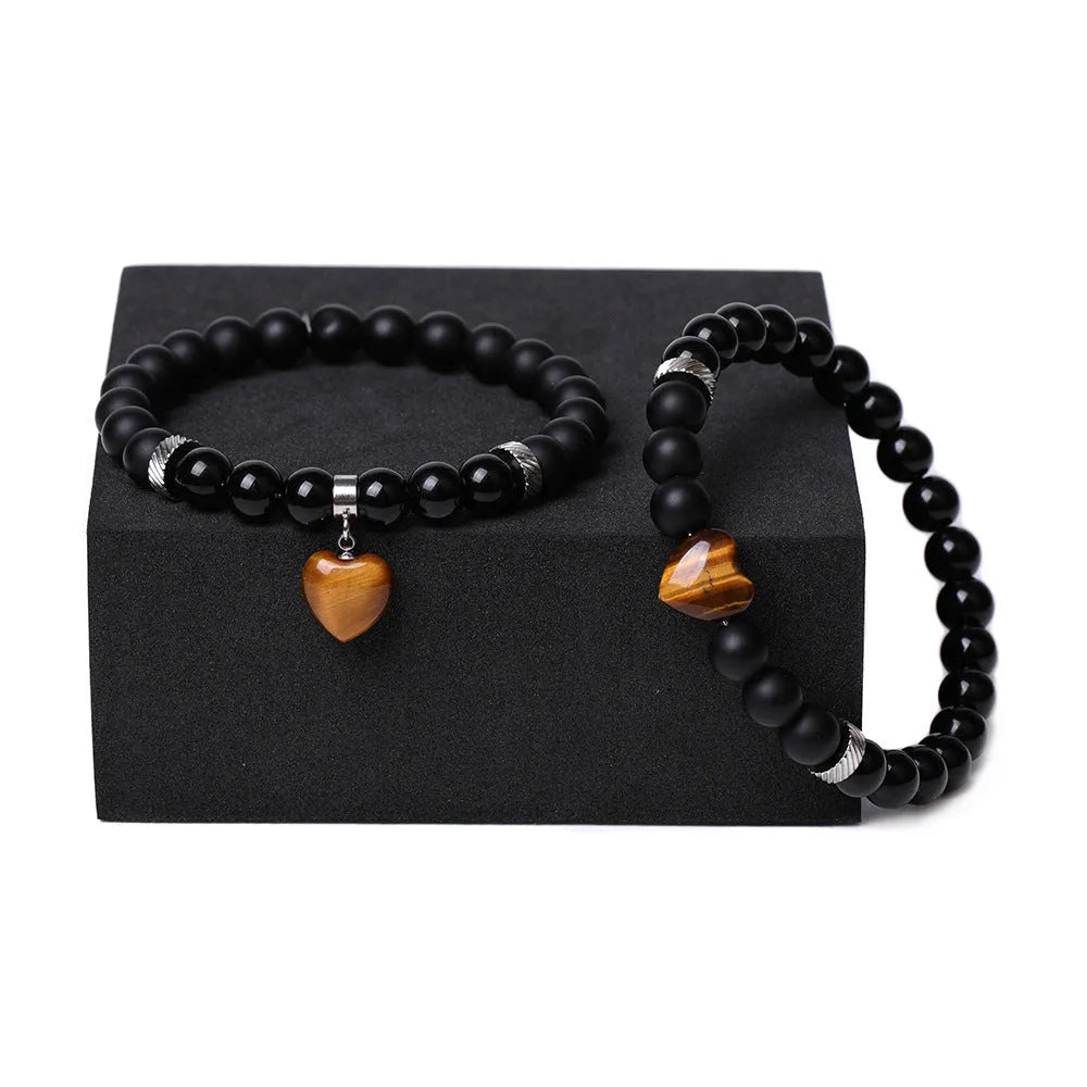 Natural stone couple bracelet set showing two matching bracelets with heart-shaped polished stone charms