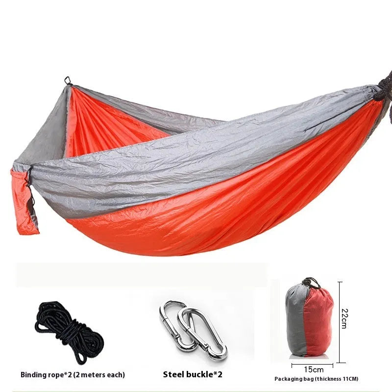 Double camping hammock with ropes and buckles shown in outdoor setting