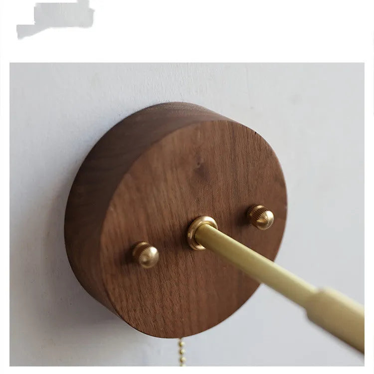 Nordic style walnut wood coloured wall-mounted bedside lamp with a fixed arm.