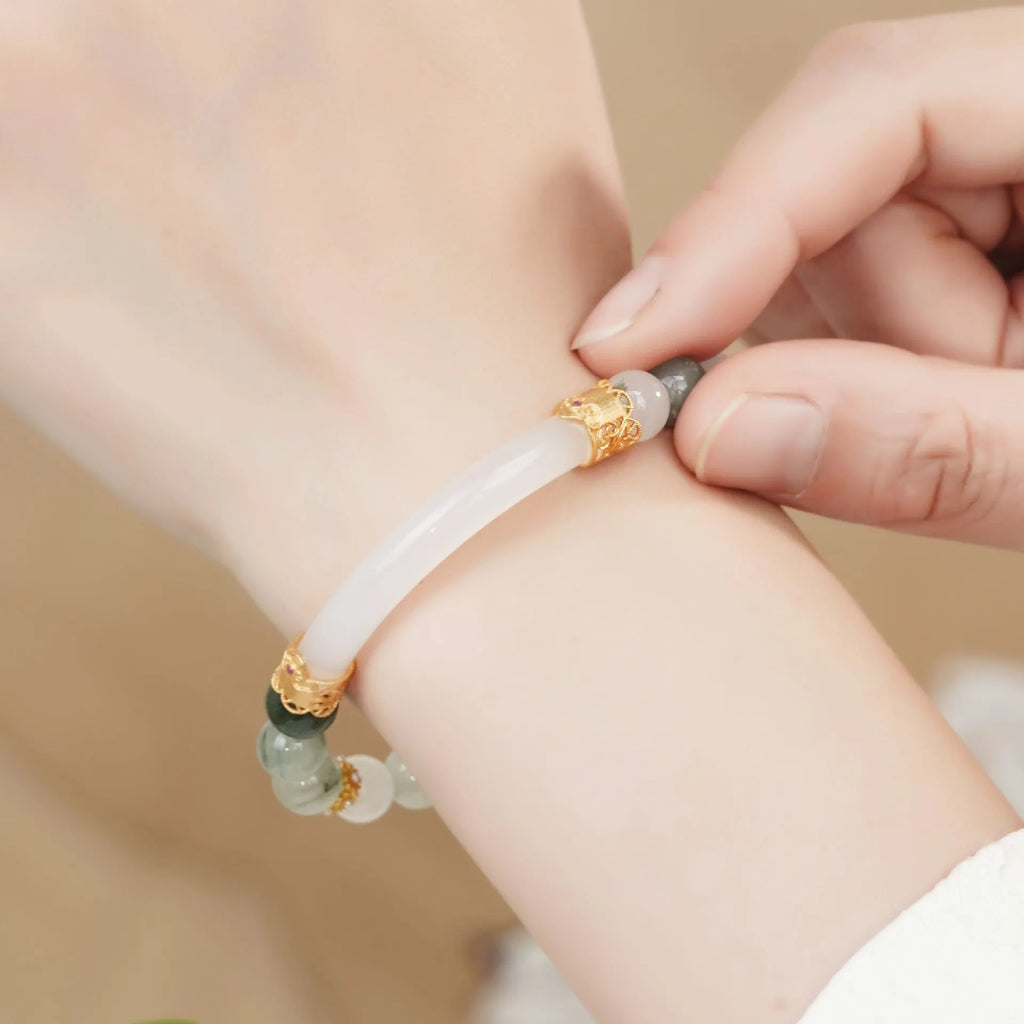 Emerald green jade bracelet with floating flower girl design in a half bracelet style.