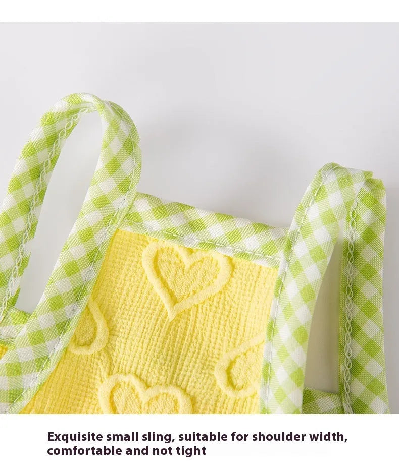 Small dog wearing heart bow suspenders vest in elastic material with decorative bow detail