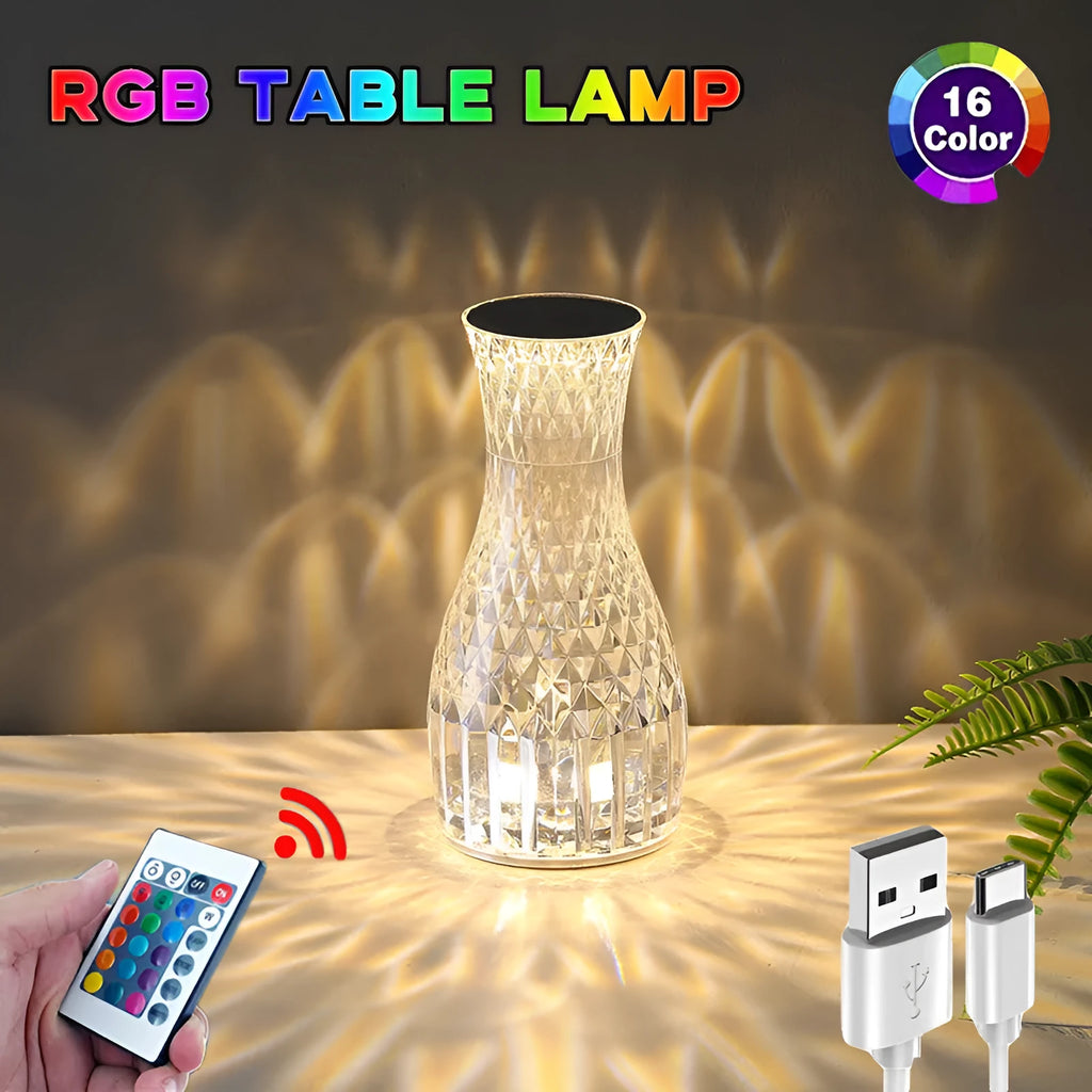 Clear plastic vase-shaped crystal bedside lamp with LED lights on a wooden table.