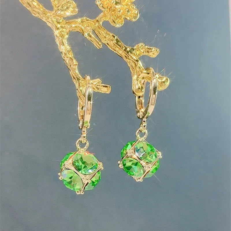 A pair of women's geometric copper earrings with a rose design and small zircon stone accents.