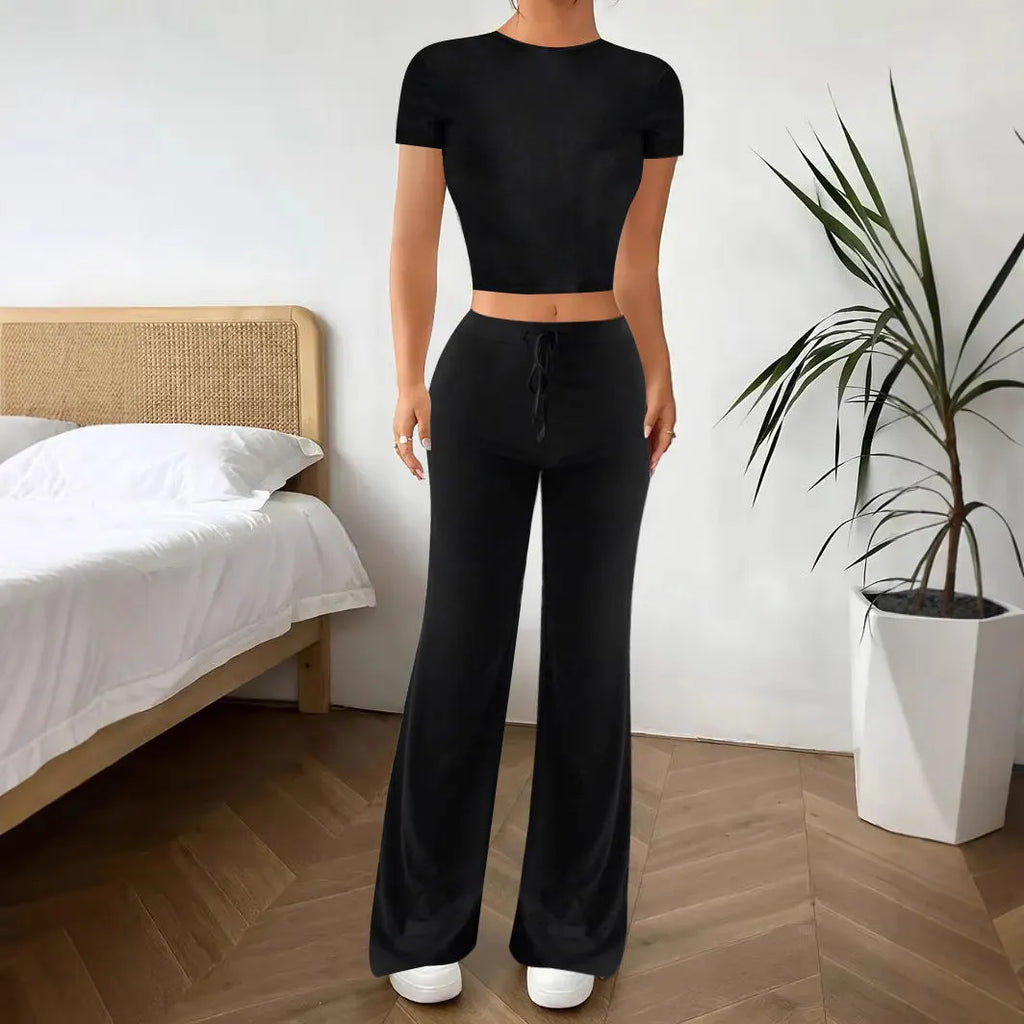 Black high waist trousers and short sleeve t-shirt matching set laid flat showing coordinated outfit