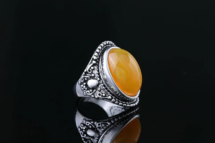 Geometric antique silver ring with fluorescent beeswax amber centre in retro style