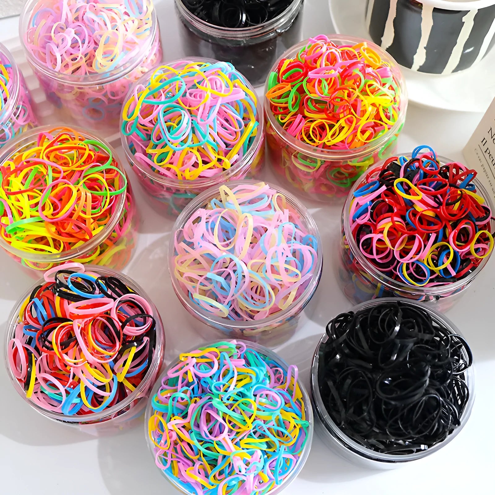 Multi-colour TPU baby hair ties for toddlers in a reusable storage container, 300 piece pack.