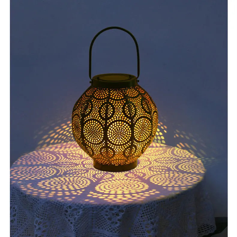 Solar courtyard lamp with hollow iron decorative design emitting warm white LED light