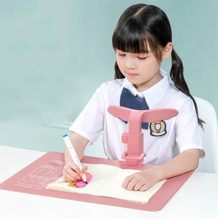 Student anti-myopia posture corrector orthosis with silicone and ABS frame, available in blue and pink, for desk or card table use