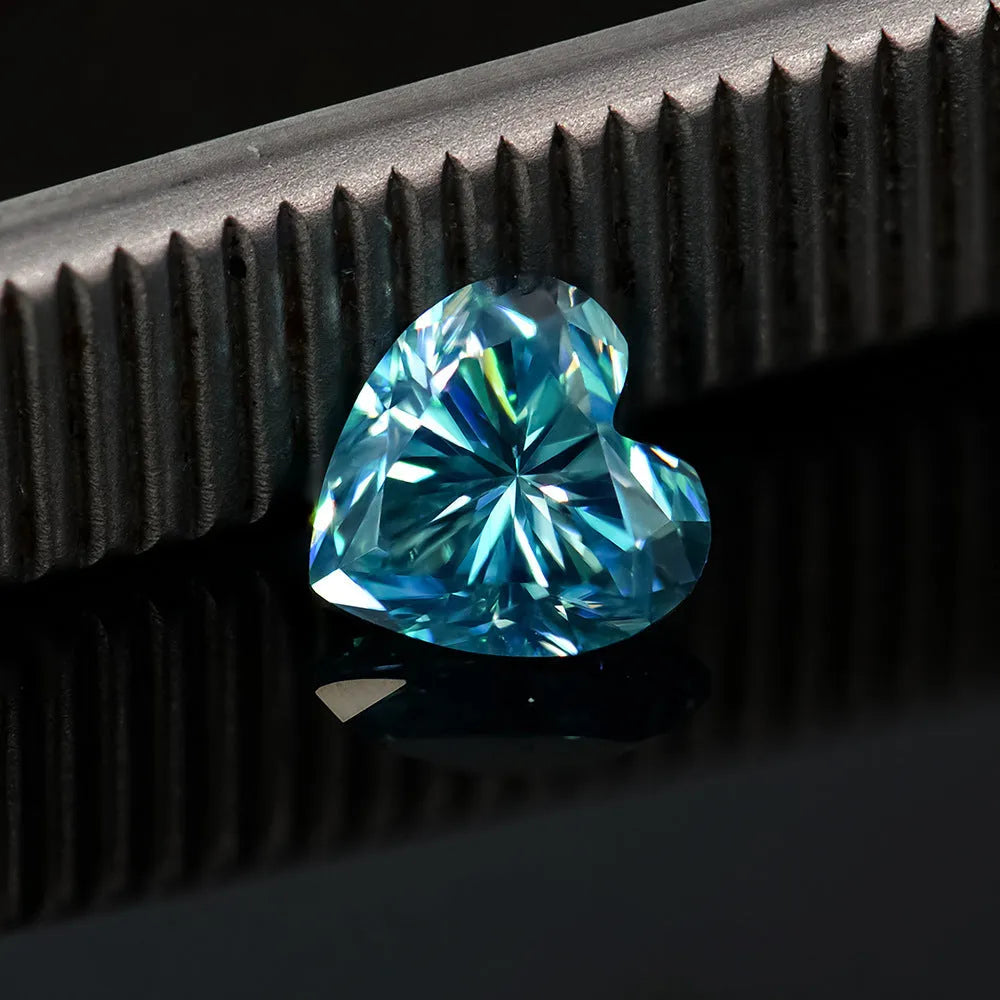 Loose lemon yellow heart-shaped moissanite stone on a plain background showing its size and cut.