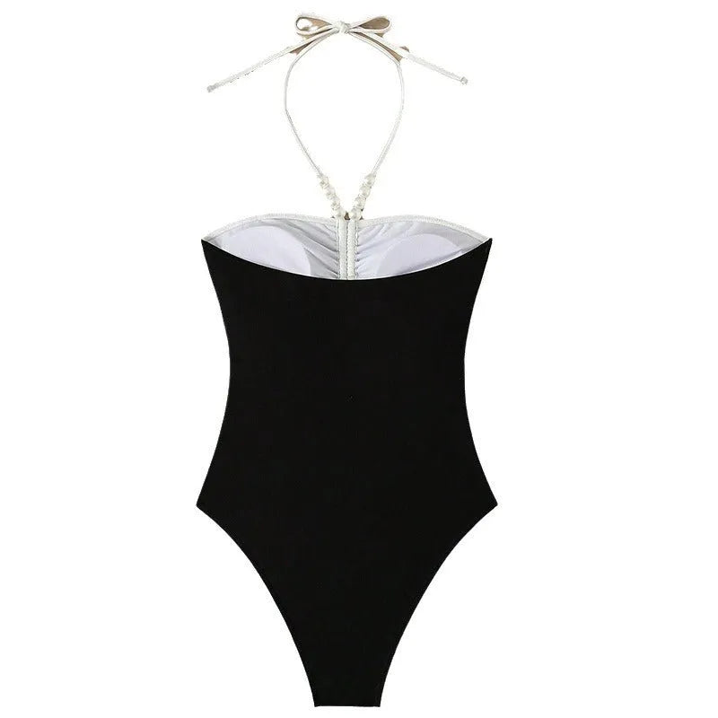 Black and white women's one-piece swimsuit with spaghetti straps and slim fit design
