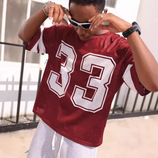 Men's mesh sports jersey in cartoon print with short sleeves and round neck in one of five colour options