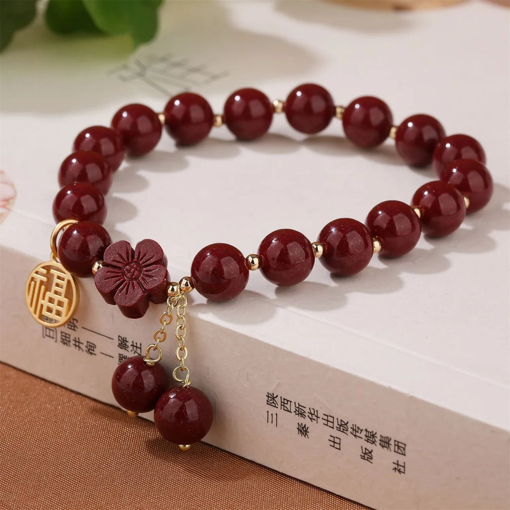 Traditional cinnabar women's bracelet with fu character centrepiece in purple and gold sand colours