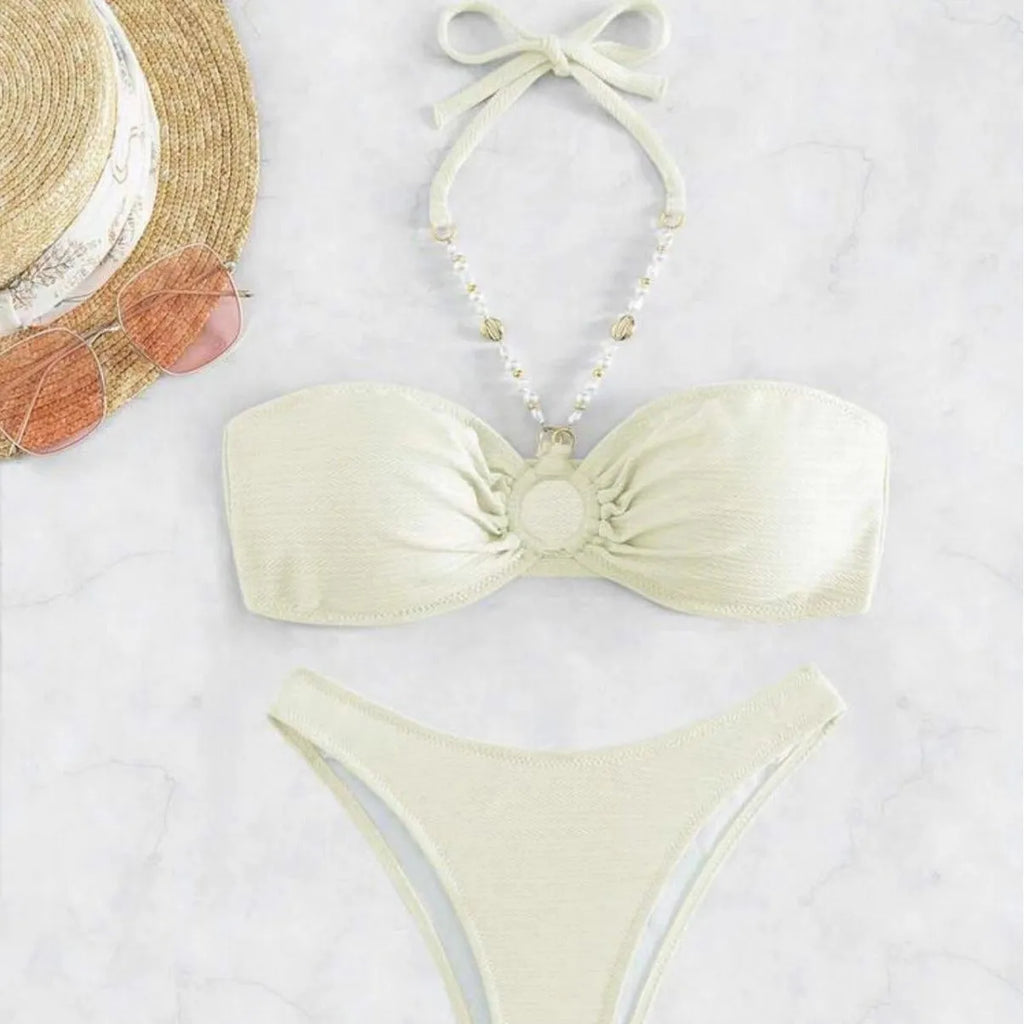 Women's solid colour halter bikini set on a mannequin, showing the halter top and briefs.