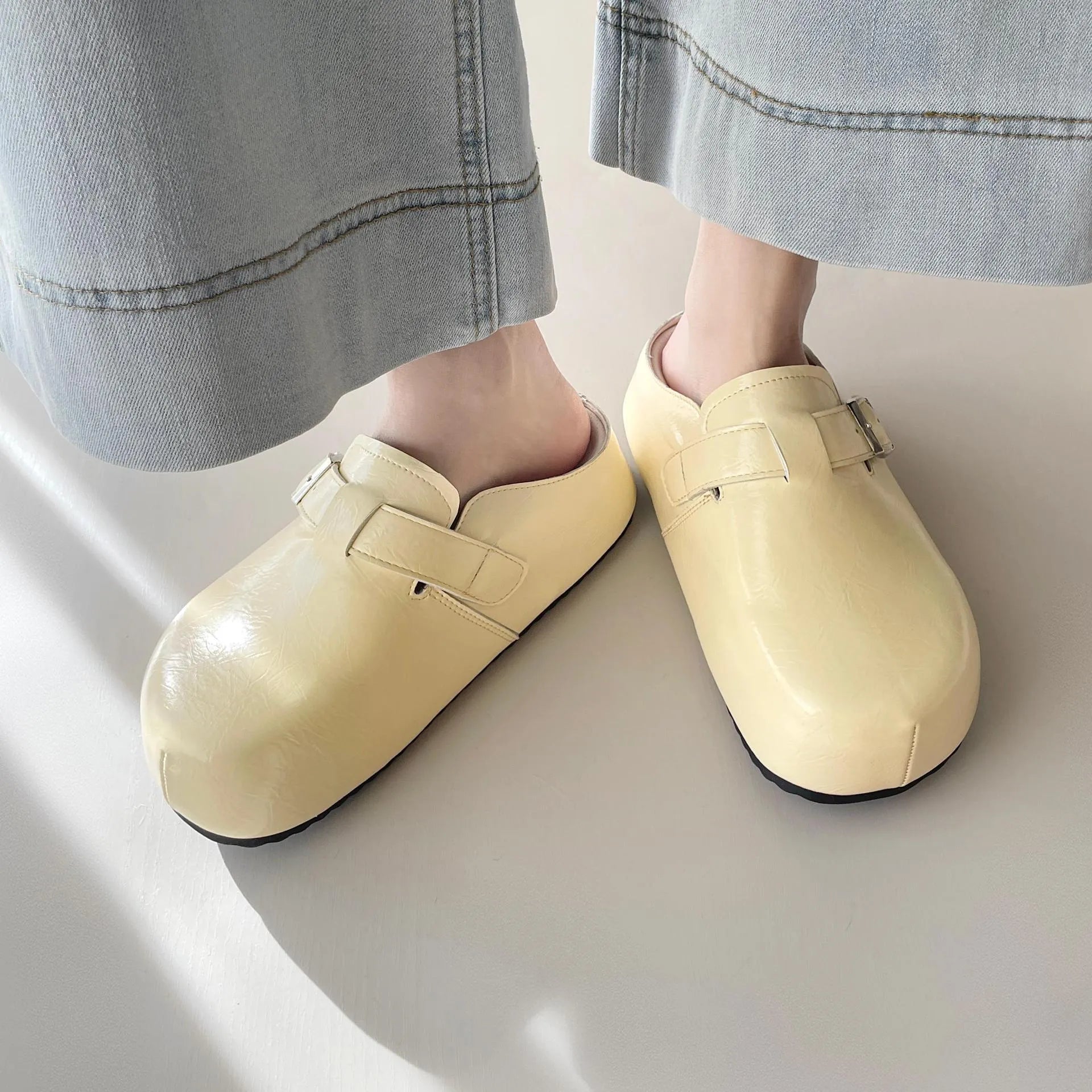 Flat buckle casual sneakers in yellow, round toe, PU upper, on a white background.