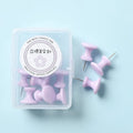 Plastic push pins in mint green, lavender, and pink, showing large and small sizes in a small box.