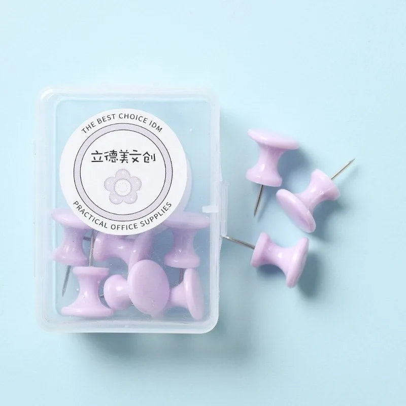 Plastic push pins in mint green, lavender, and pink, showing large and small sizes in a small box.