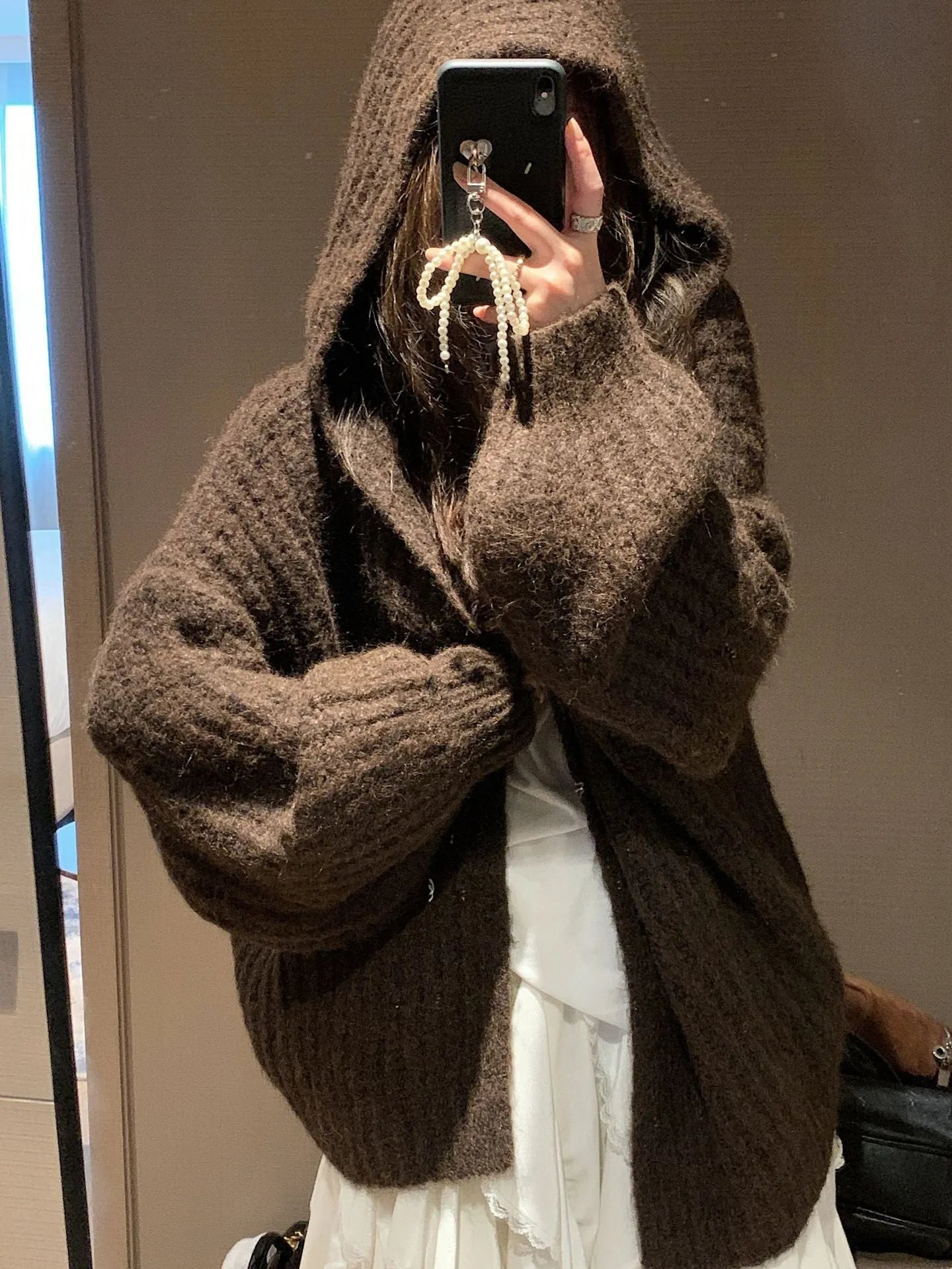 Women's loose hooded cardigan in thick acrylic blend, shown in dark grey, brown, and milky white.